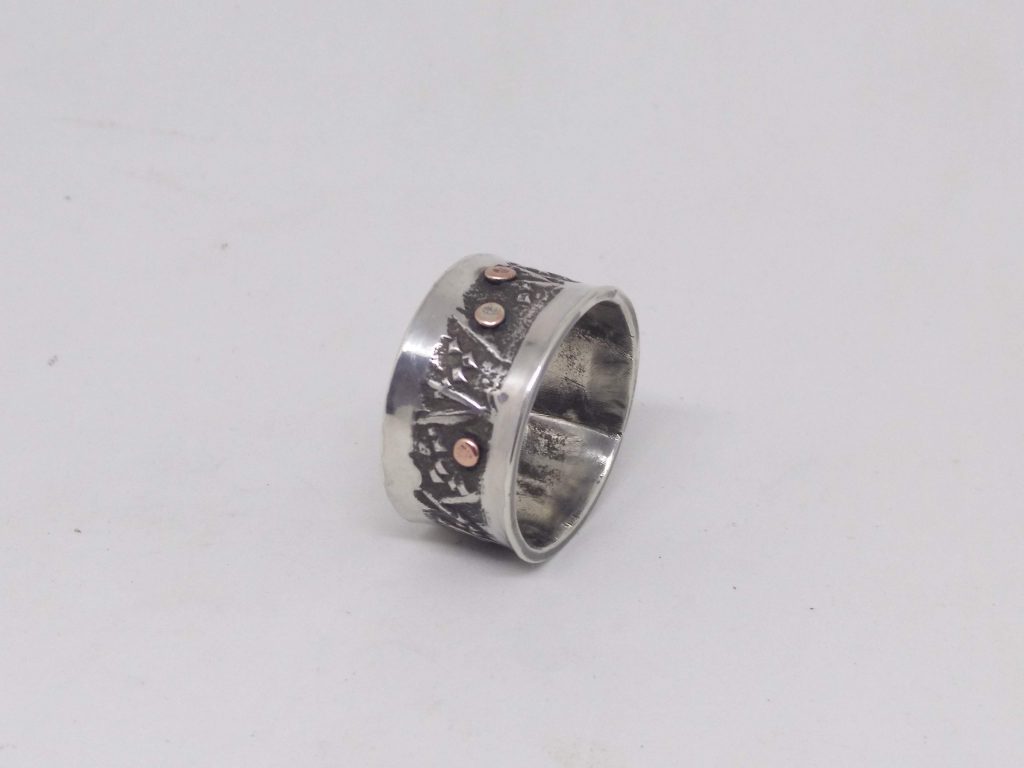 silver ring with copper dots
