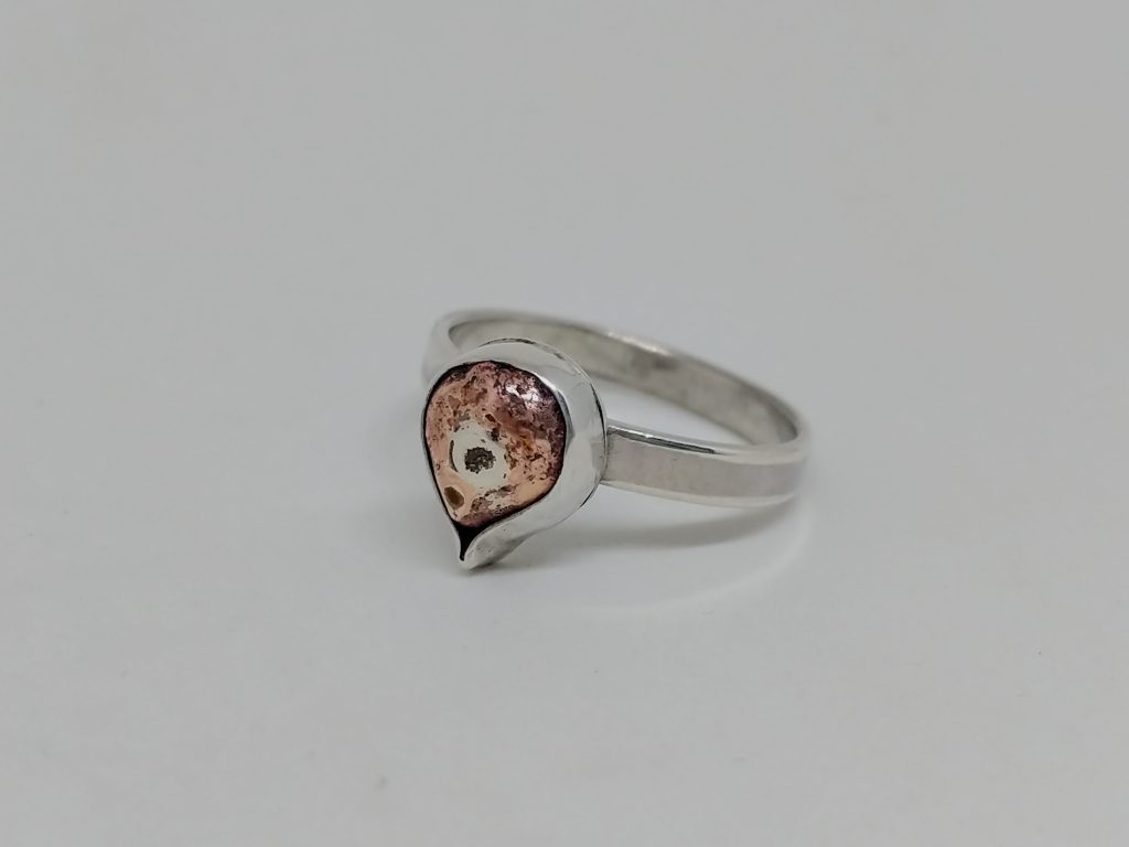 silver ring set with copper teardrop