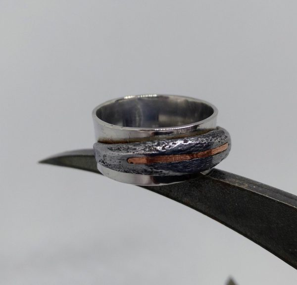 Silver ring with iron and copper detail