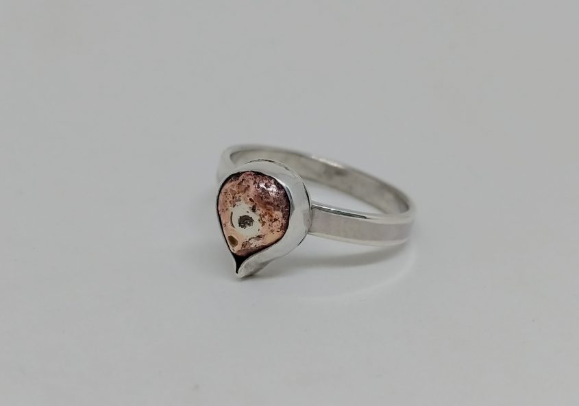 silver ring set with copper teardrop