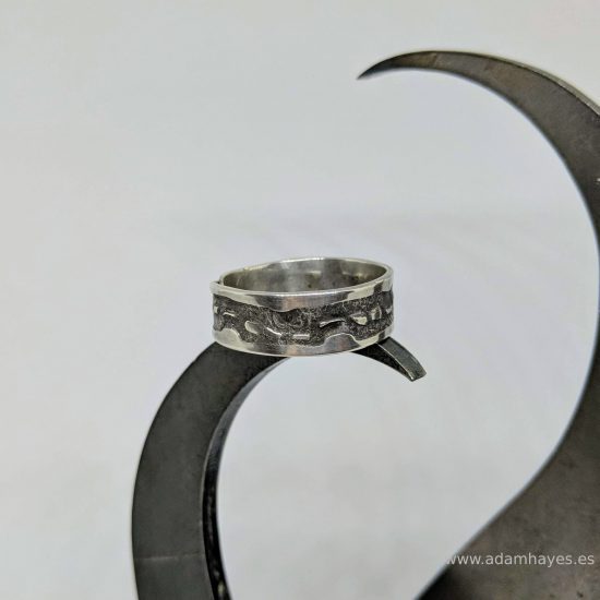 Silver ring with textured overlap