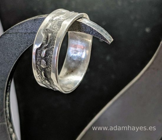 Silver ring with textured overlap